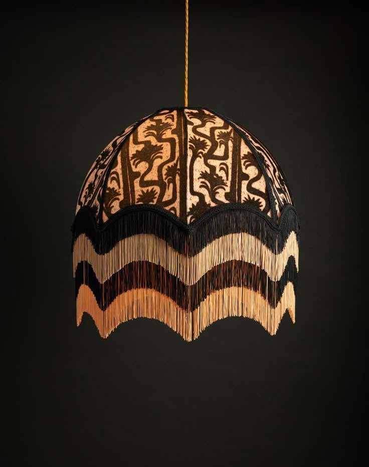 A woven pendant lamp glowing against the dark